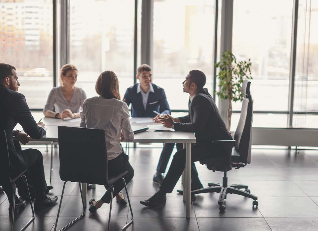 General Liability Insurance - Manager Leads Personnel Meeting with Business Colleagues and Brainstorms Together in a Conference Room of a Modern Office with Large Windows