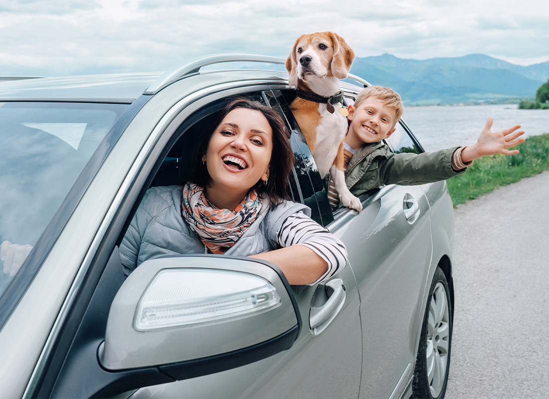 Personal Insurance - Happy Family Looking Outside From the Car Windows on a Drive
