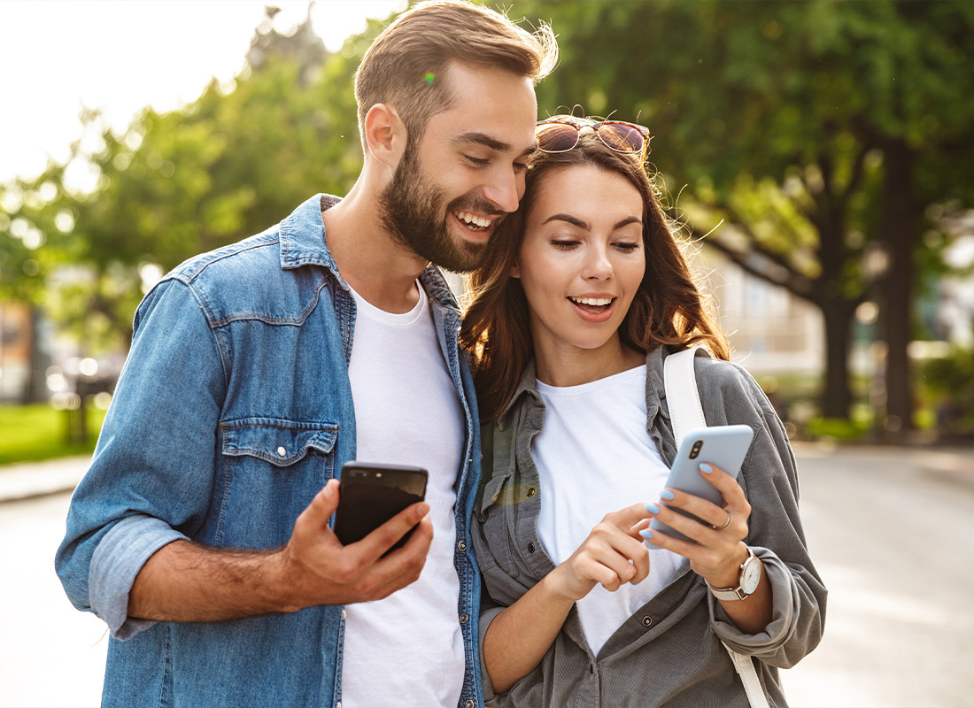 Read Our Reviews - Young Couple Walking Outdoors on a City Street During the Day